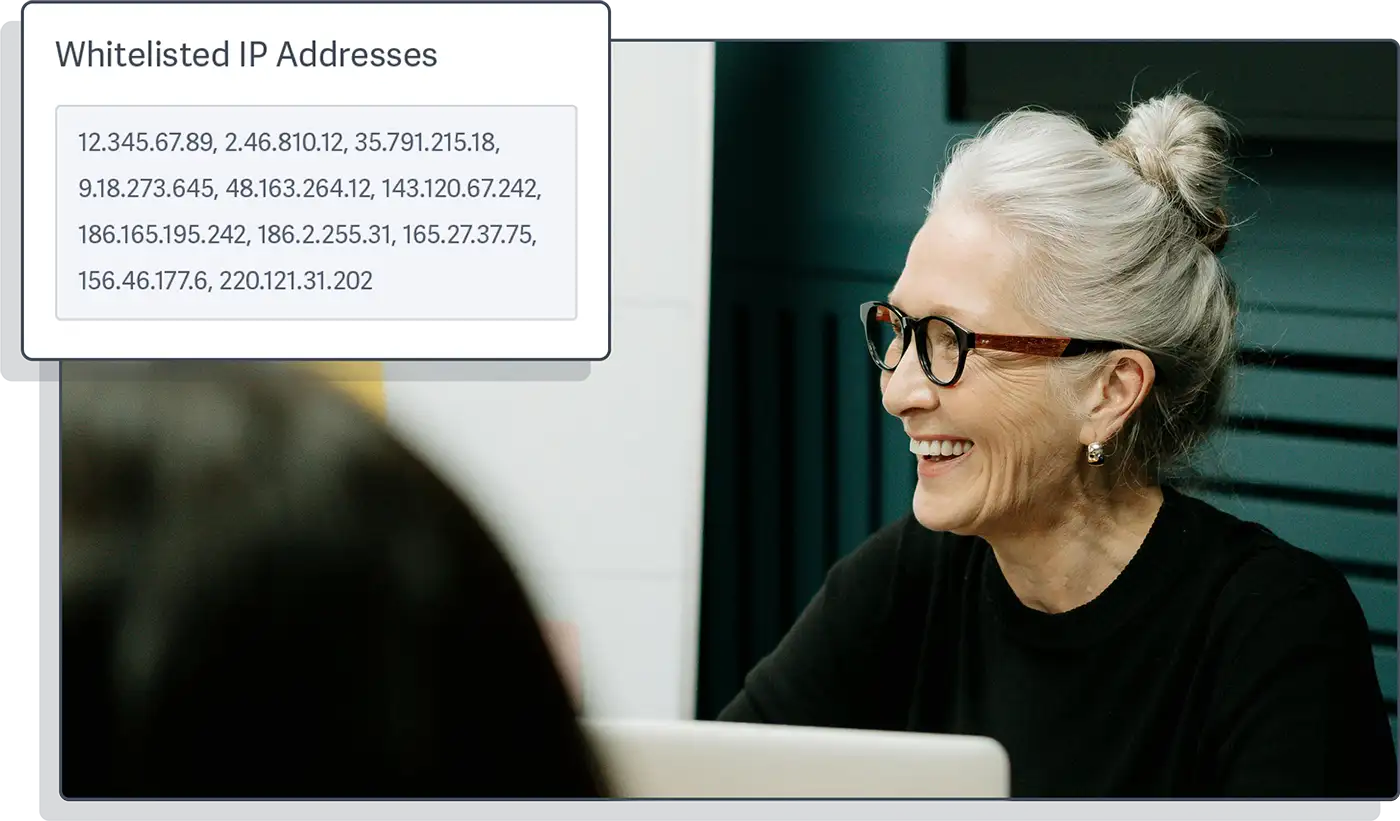 Image of a professional woman conducting a meeting with a stylized example of the UI for whitelisting IP addresses from the SproutVideo platform overlaid